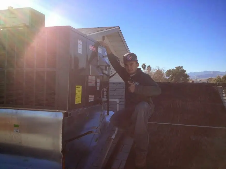HVAC technician performing Boiler Repair on a rooftop unit in Buckingham